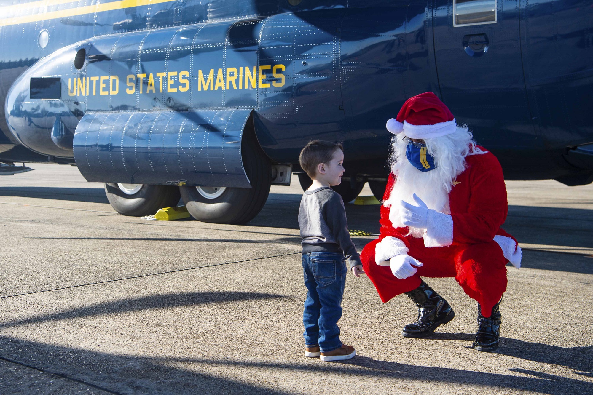 Santa speaks with a child while joining the Blue Angels, the Navy’s flight demonstration squadron, to support the Marine Corps Toys for Tots program by delivering toys and games to families impacted by the COVID-19 pandemic and multiple hurricanes in Lake Charles, La., Dec. 8, 2020.