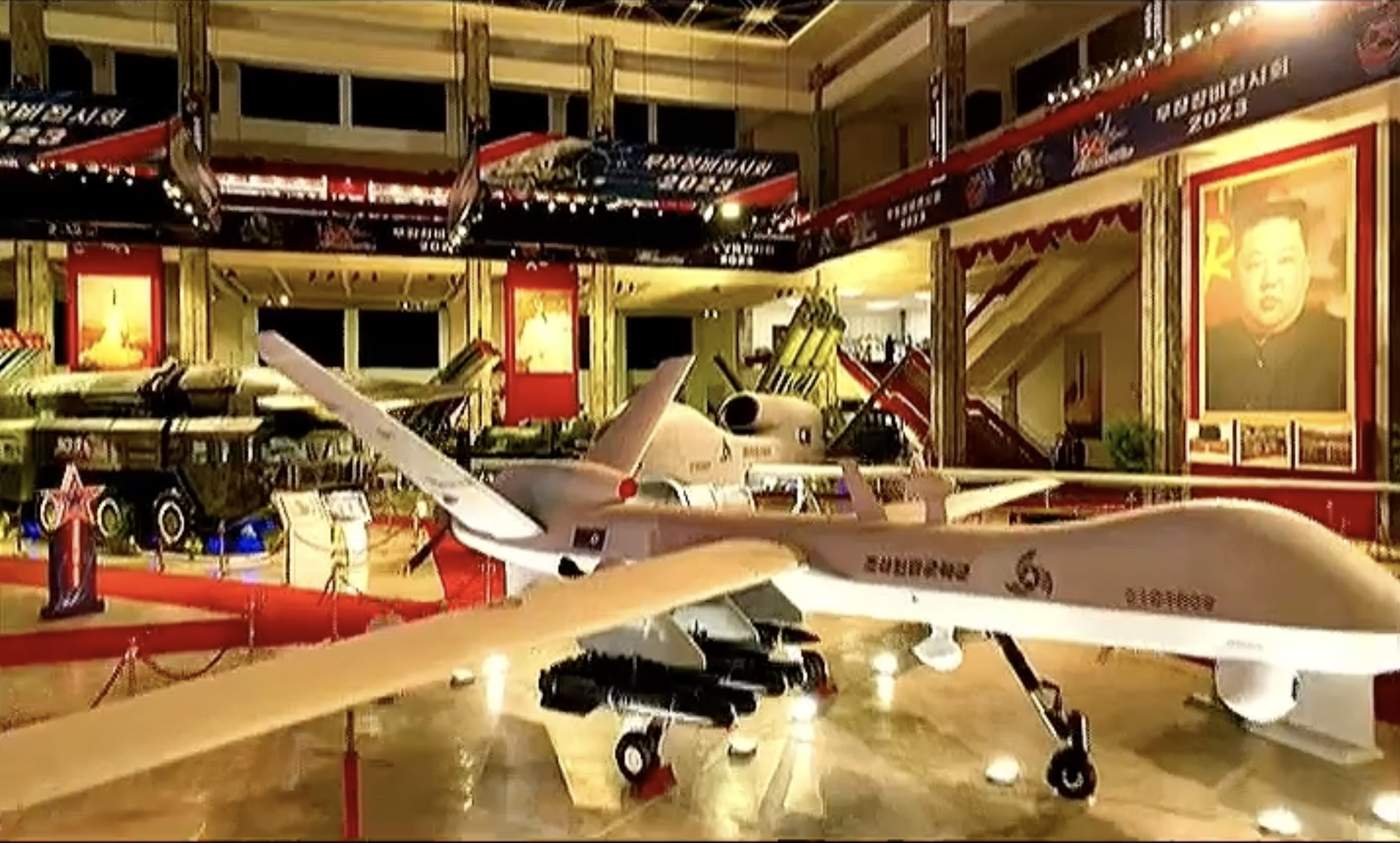 North Korean drones striking similar to the MQ-9 Reaper and RQ-4 Global Hawk are seen during a weapons exhibit publicized by the state media.